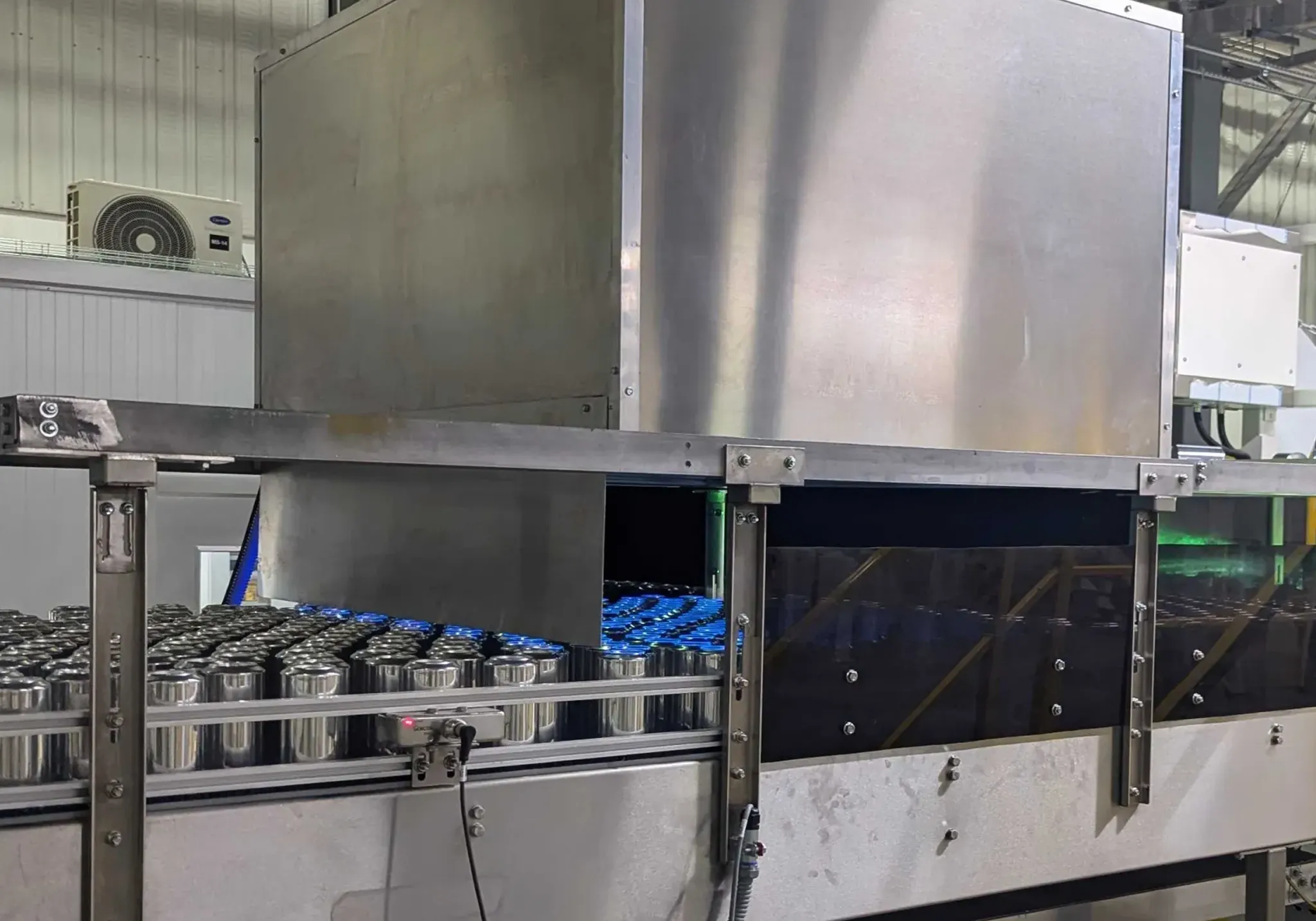 UVBC Inspection system hardware installation. This is the metal blackout light box over the production line.