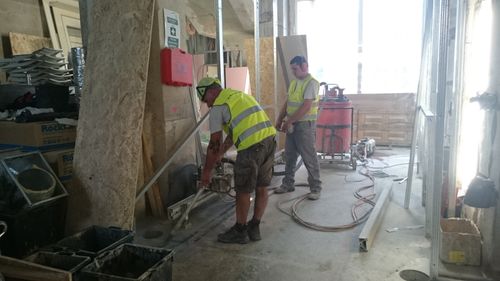 Two operators engaged in cutting with diamond tools during demolitions