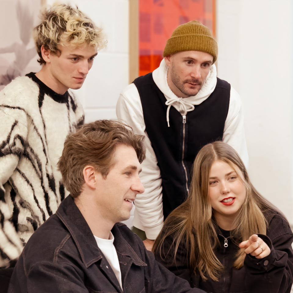 Team members Nathan Smith, Edoardo Albertini, Meg Mardon and Charlie Hocking stood looking at a computer screen.