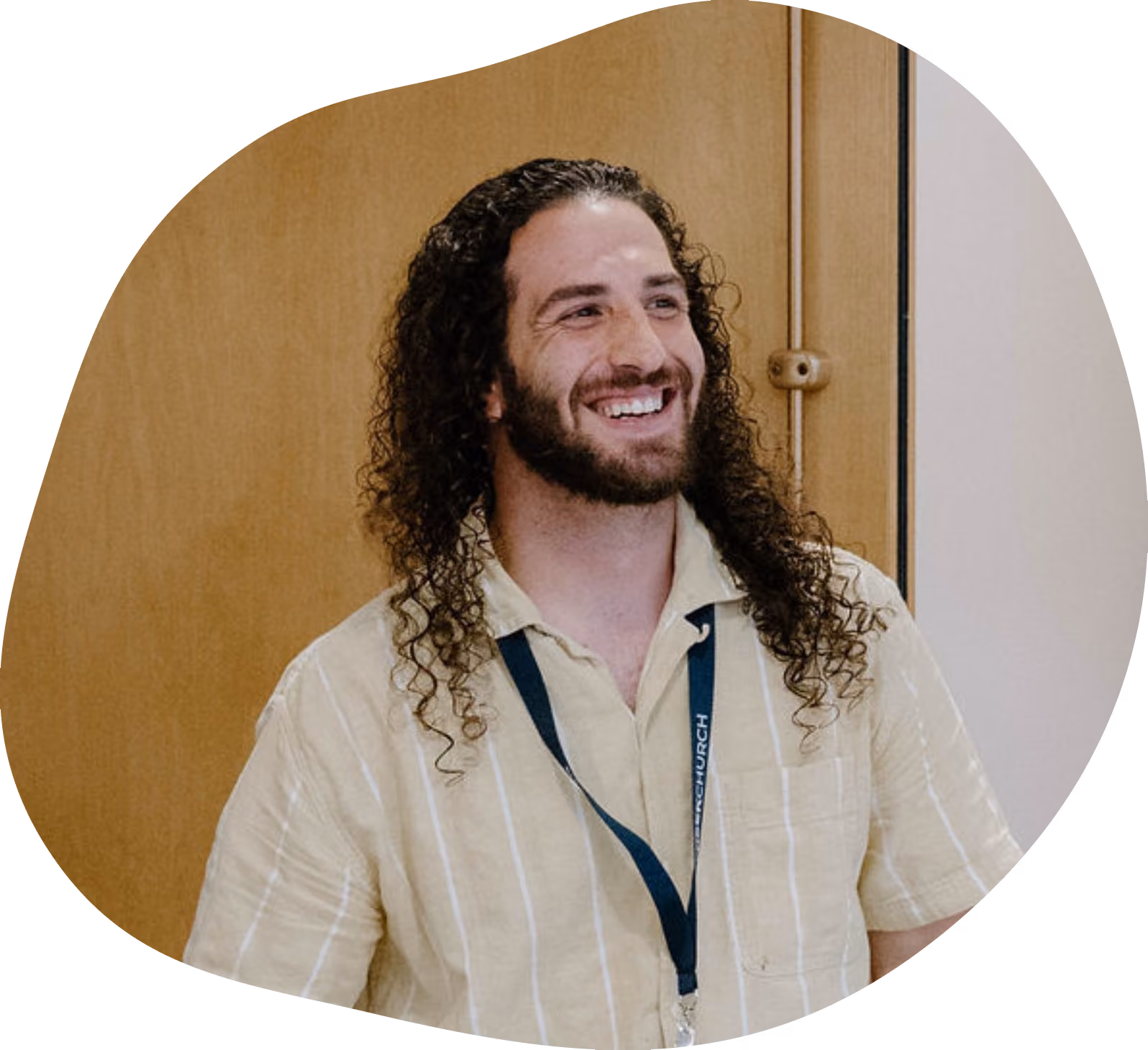 Dominic Cummings Long Haired Man Standing in Door way Smiling and Excited to Serve