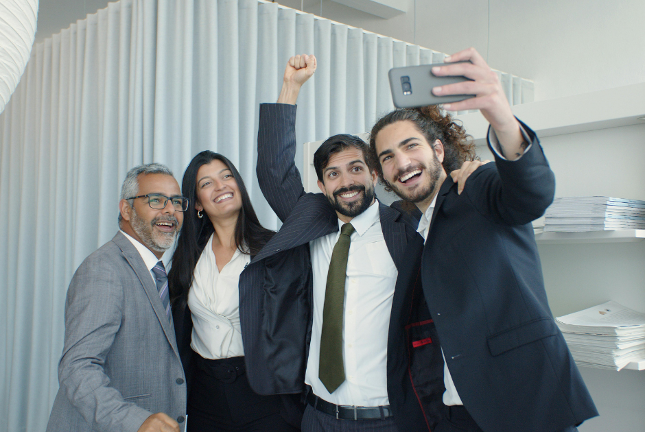 A casual office setting with a lawyer recording a short video on their phone.