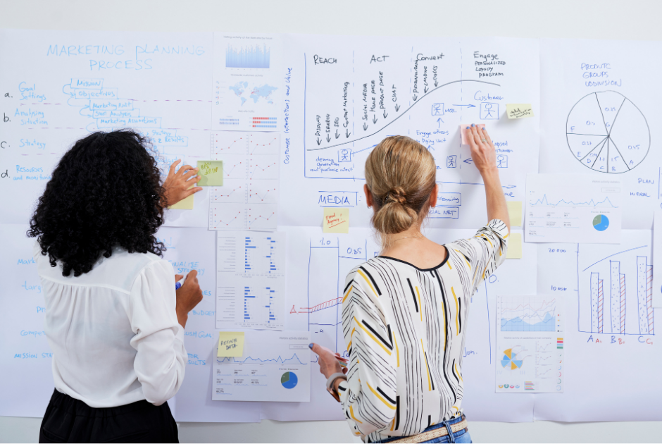  A lawyer writing out goals on a whiteboard labeled "Marketing Plan."