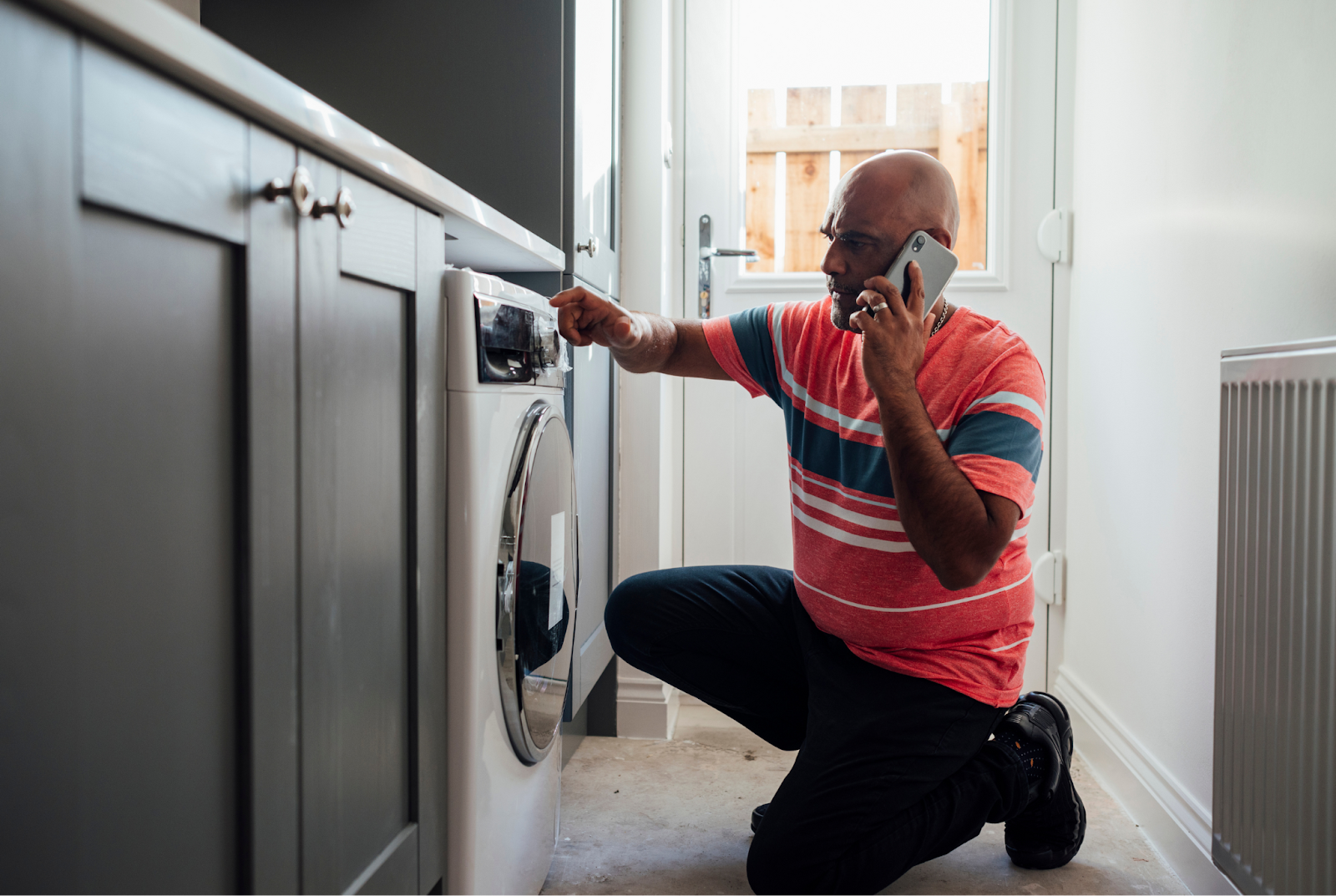 Home services client calling local plumber for help with washing machine