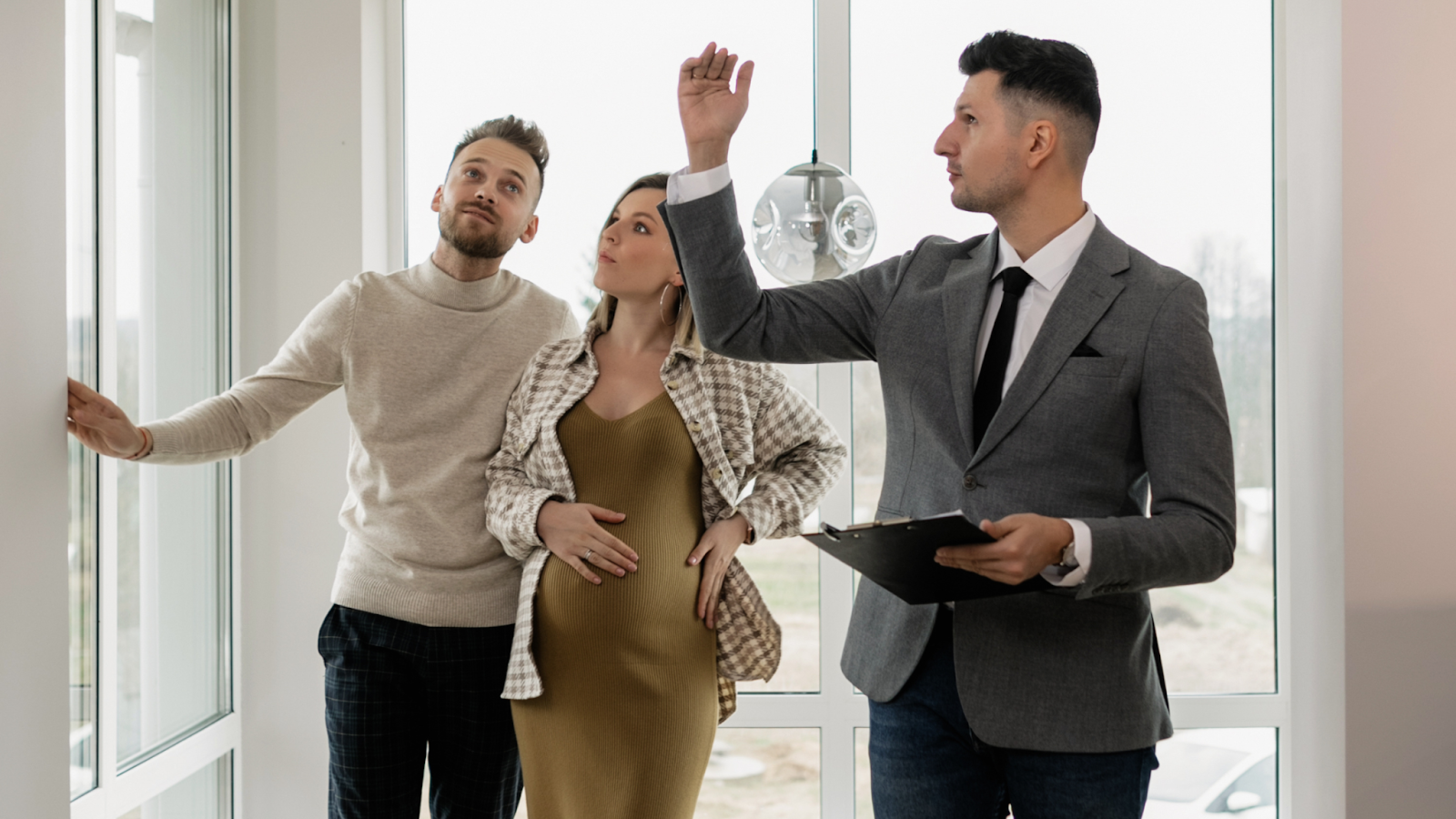 Real Estate agent giving a house tour to happy clients