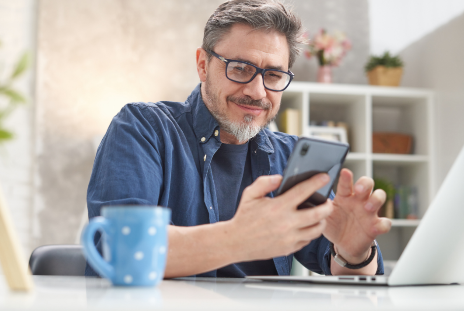 A close-up of someone reading a life insurance email on their phone with a thoughtful look on their face.