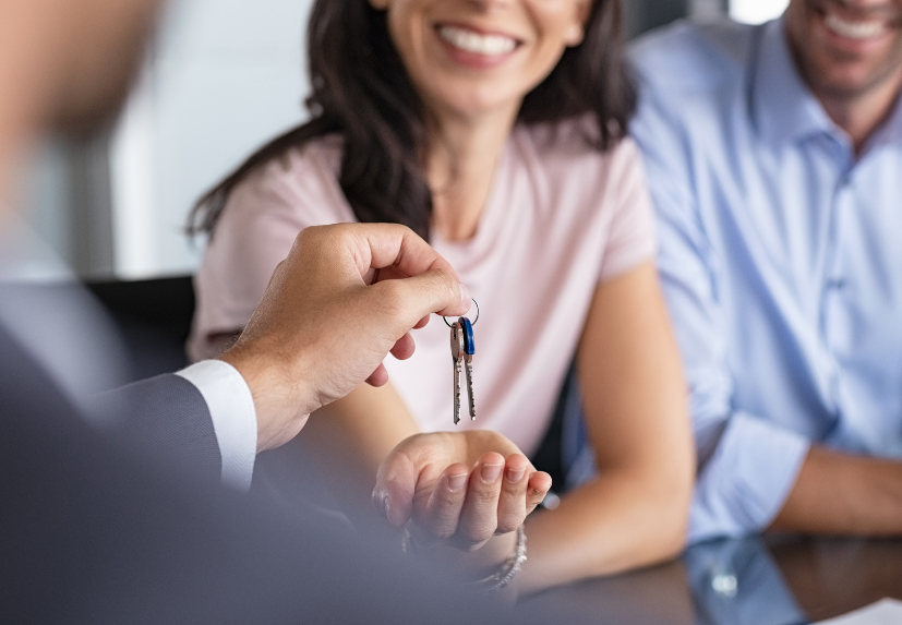 Real Estate agent closing deal with happy clients