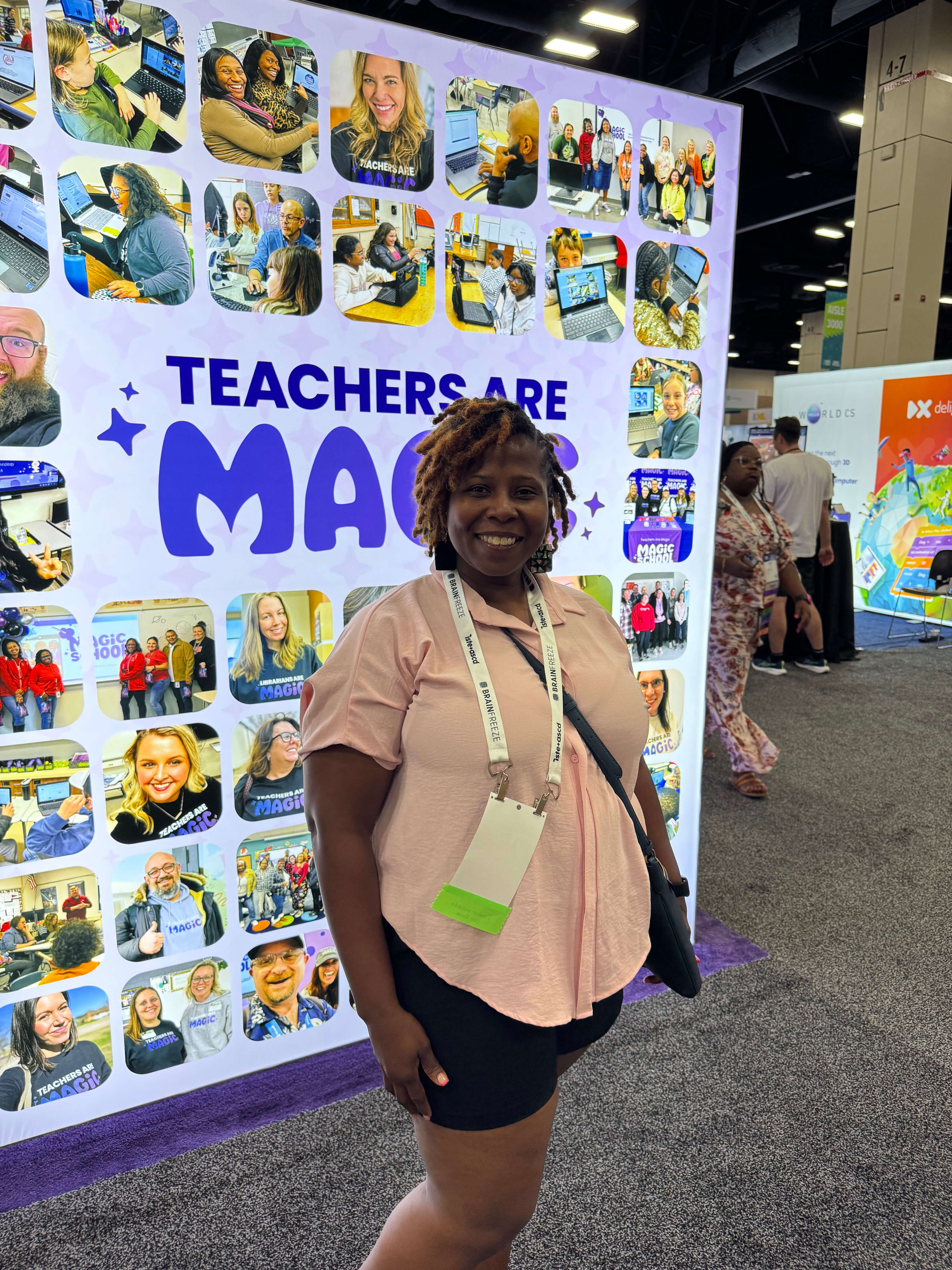 Teacher posing in front of Wall of Love