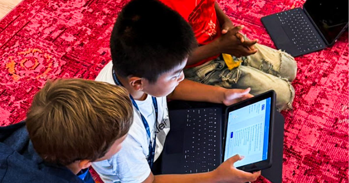2 students using MagicSchool together on a laptop