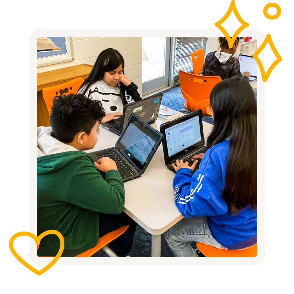 3 students sitting a table using MagicSchool on their laptops