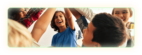 5 smiling students standing in a circle and giving each other high fives.