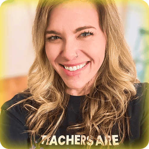 Image of a female teacher with blonde hair smiling and wearing a black Teachers Are Magic t-shirt.