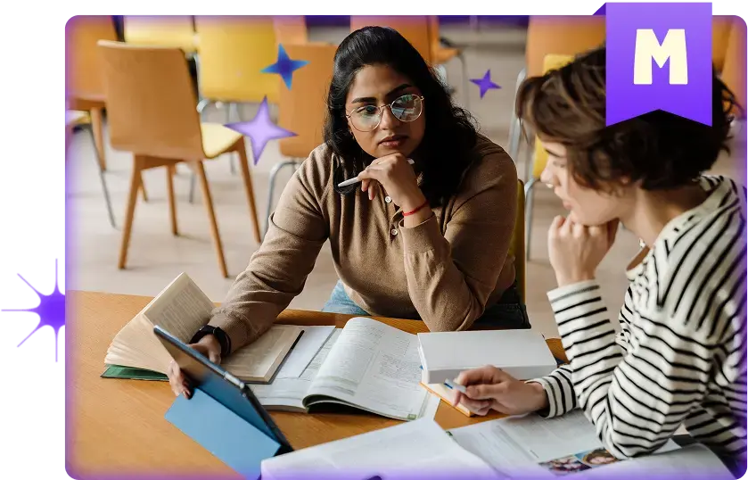An educator and student collaborating at a table, reviewing books and notes while discussing content on a tablet, representing collaborative teaching and supported learning with MagicSchool.