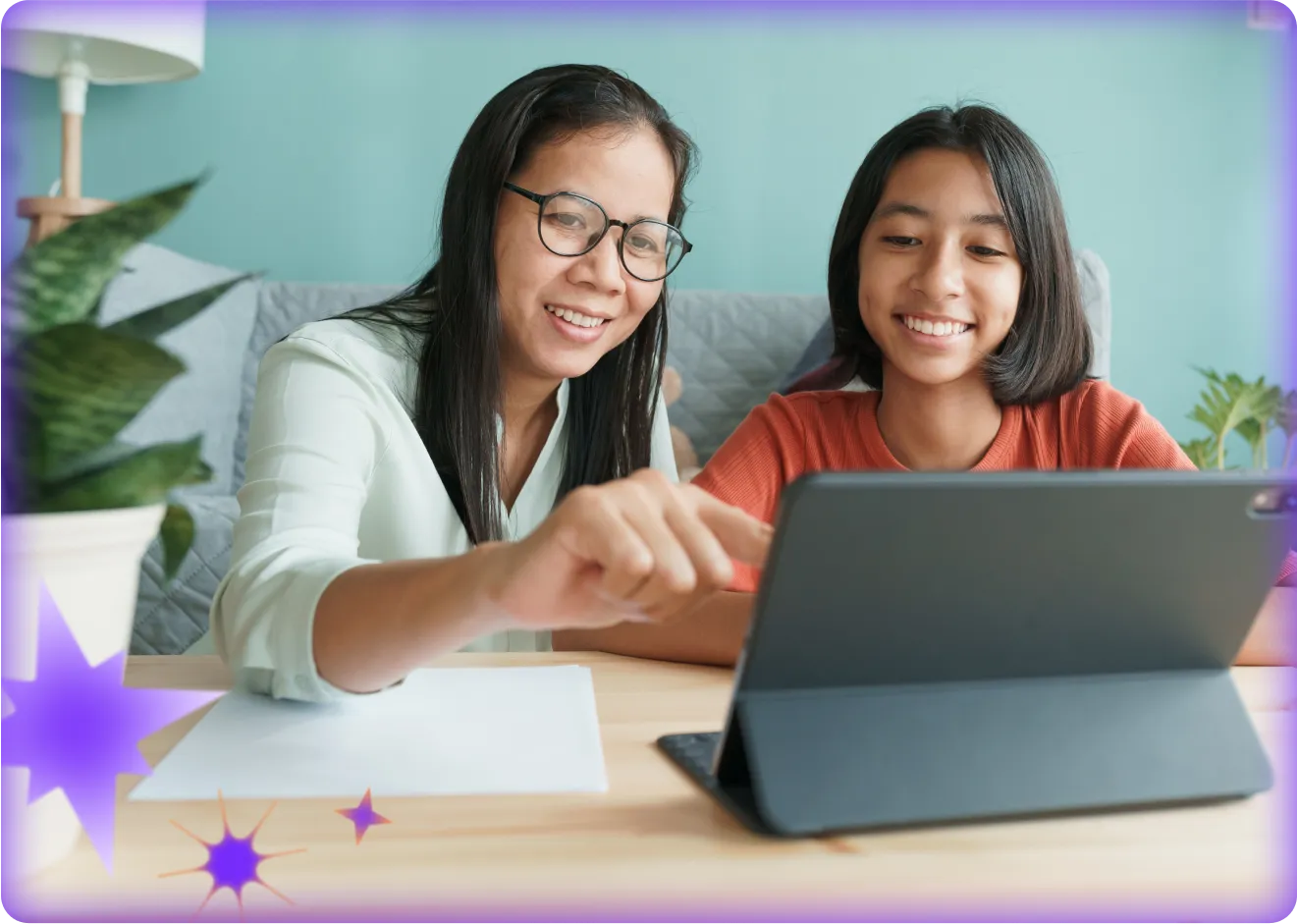 Teacher and student sitting at a table, using an AI platform together on a tablet.