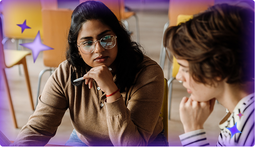 A teacher attentively listens and engages one-on-one with a student in a classroom