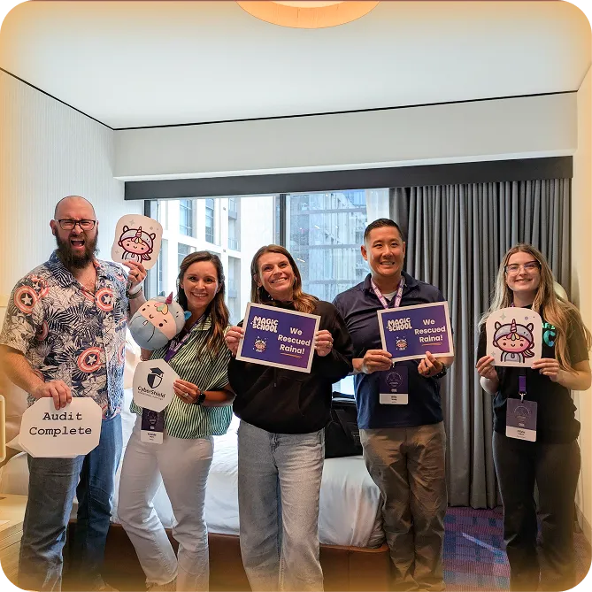 A group of 5 MagicSchool employees posing for a photo and holding signs during an escape room style event.
