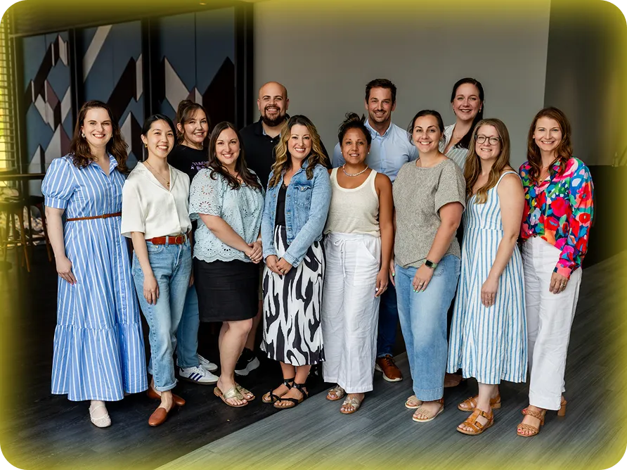 A group of 12 MagicSchool employees posing for a photo.