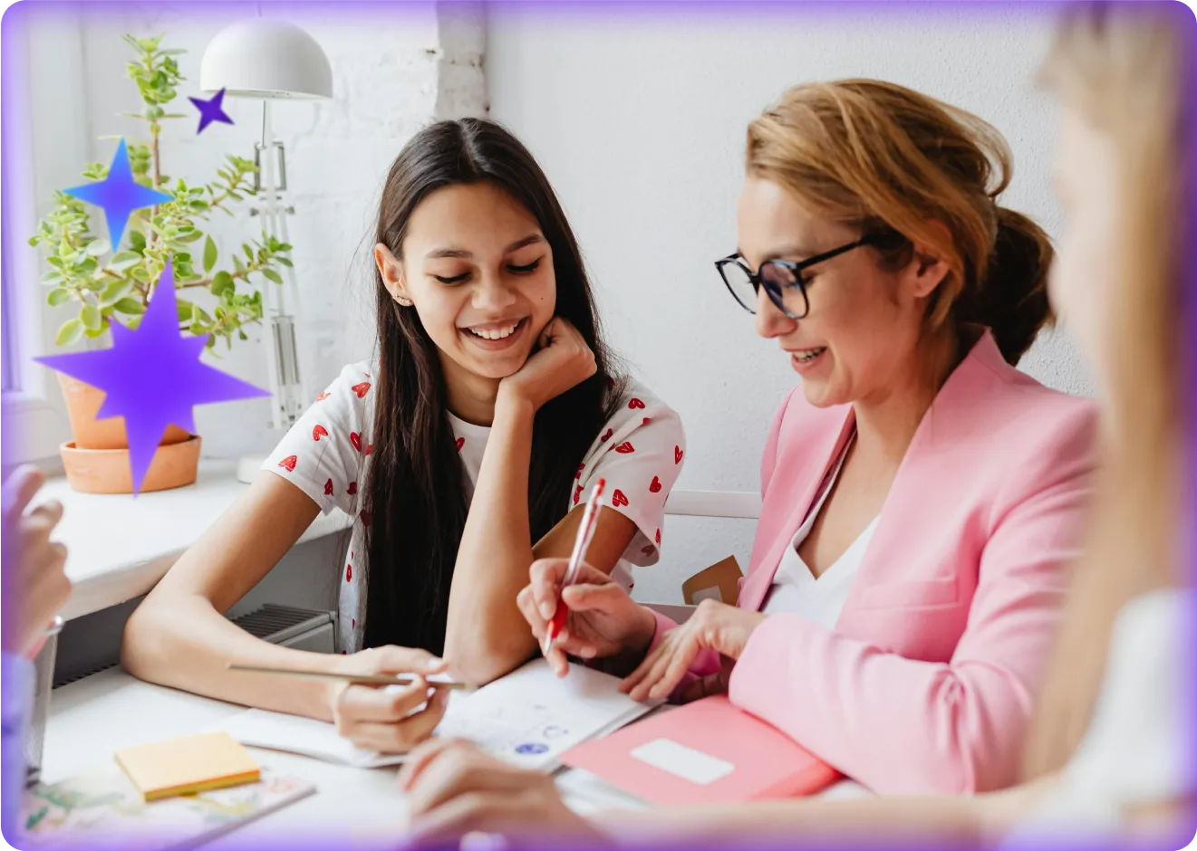 Image of an educator sitting next to s student at a desk overlaid with star graphics.