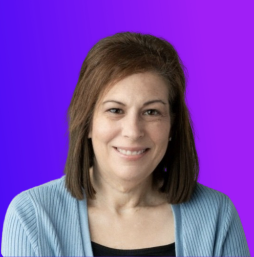 Portrait of Julie Grayson, Professional Development and Community Specialist at MagicSchool AI, smiling against a purple background.