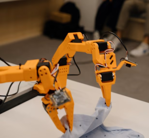 Robotic arms handling fabric