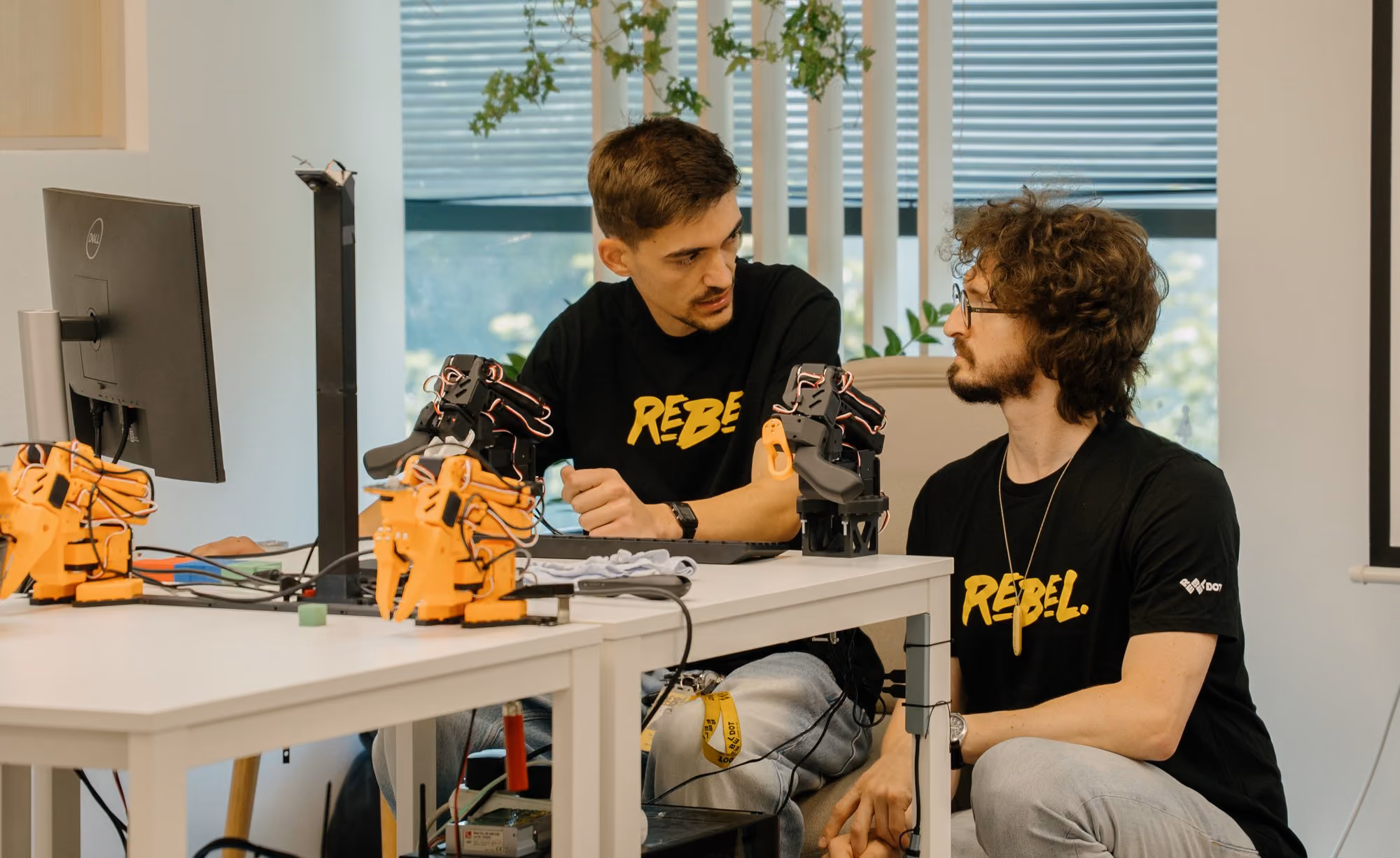 RebelDot engineers working with robotic arm prototypes