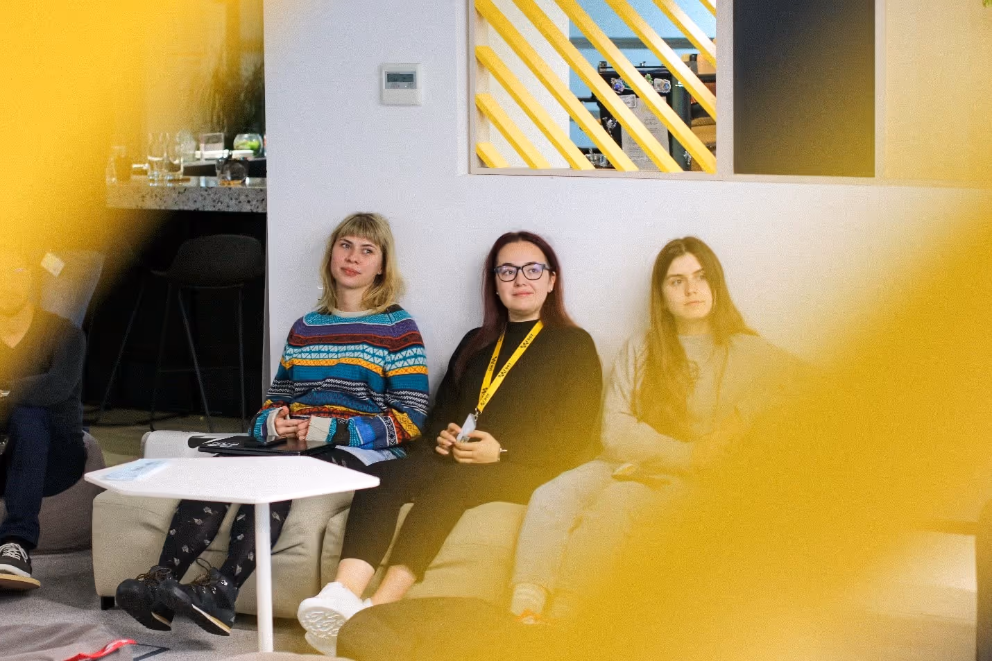 A group of women sitting on a couchDescription automatically generated