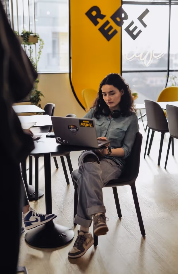 A person sitting in a chair using a computerDescription automatically generated