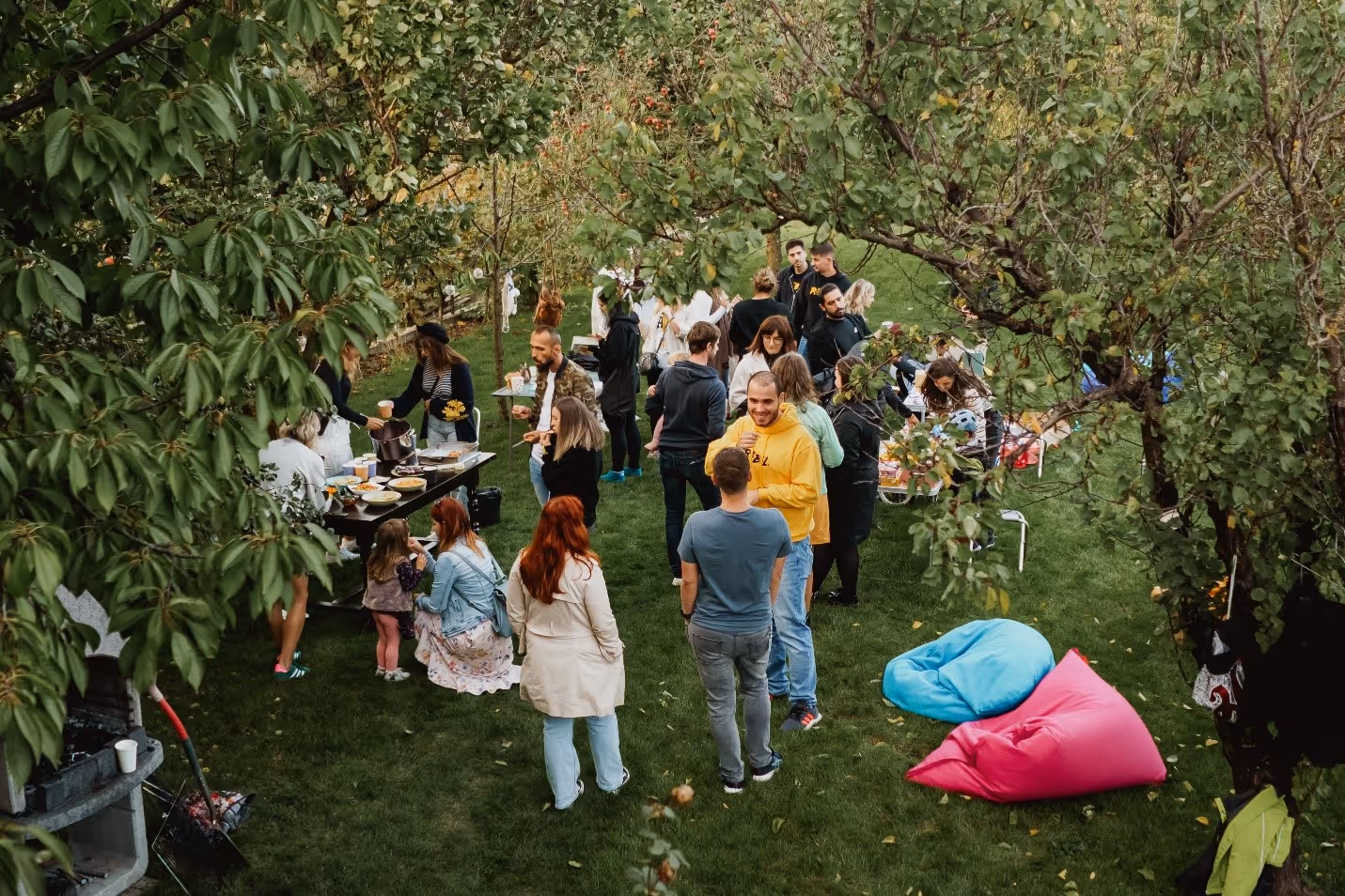 A group of people standing around a tableDescription automatically generated