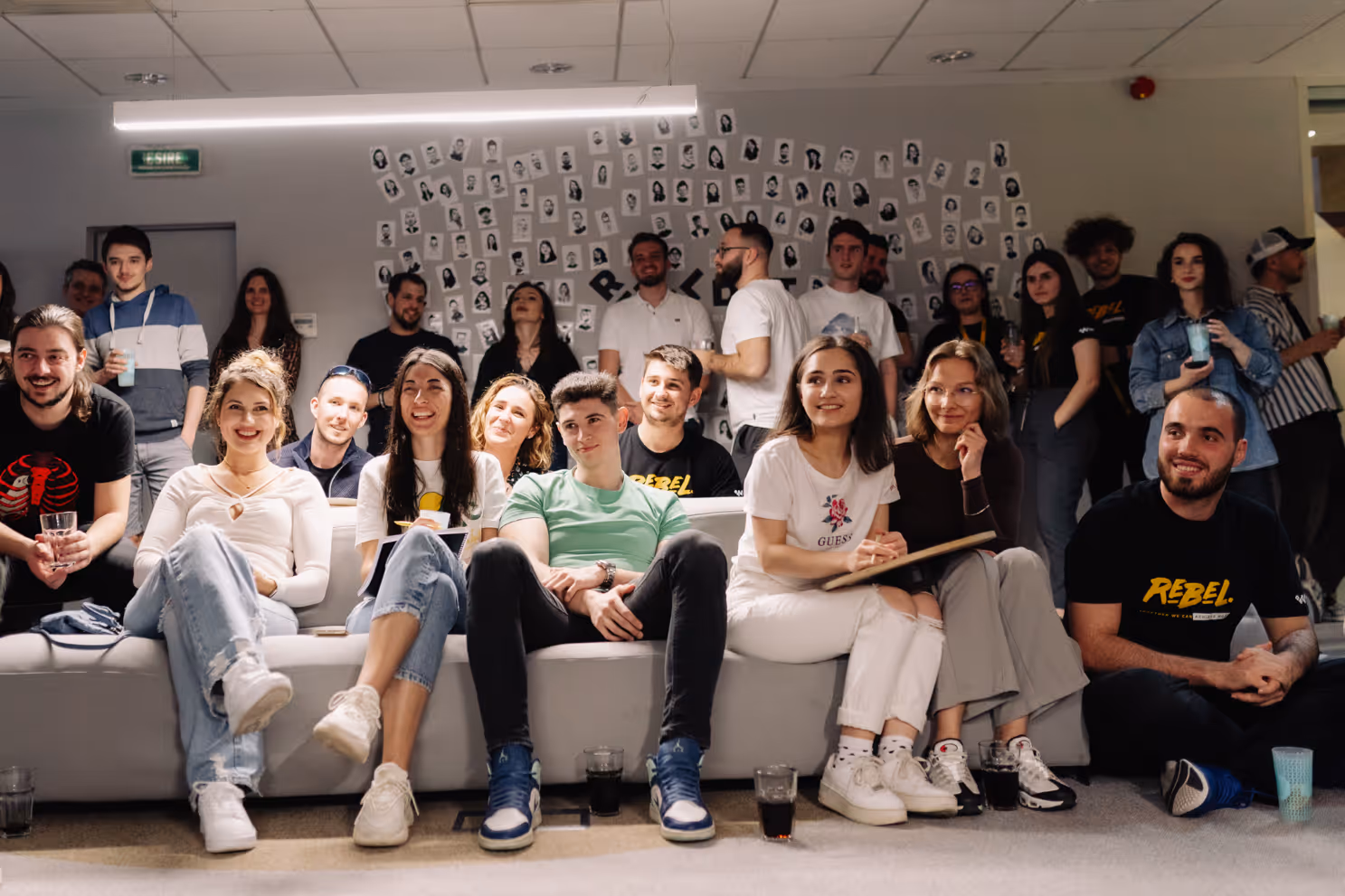 A group of people sitting on a couchAI-generated content may be incorrect., Picture