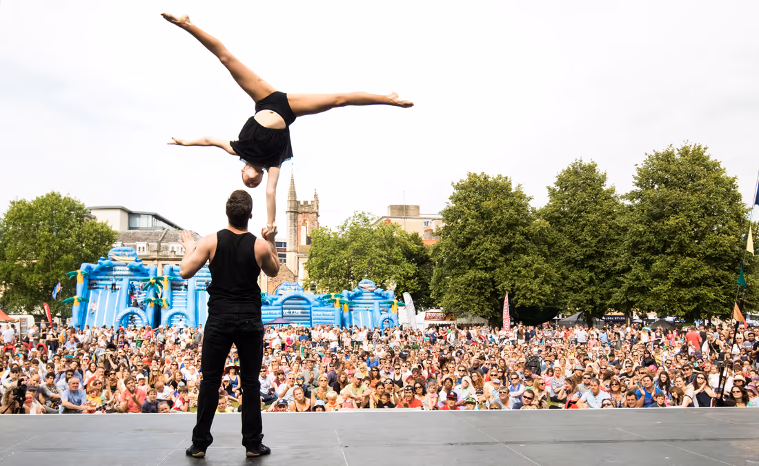 Gymnasts performing infront of large crowd