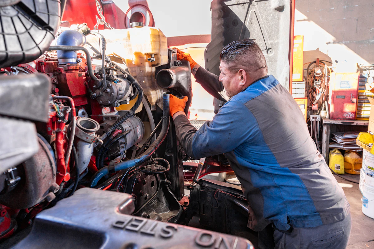 mechanic changing the coolant on a truck
