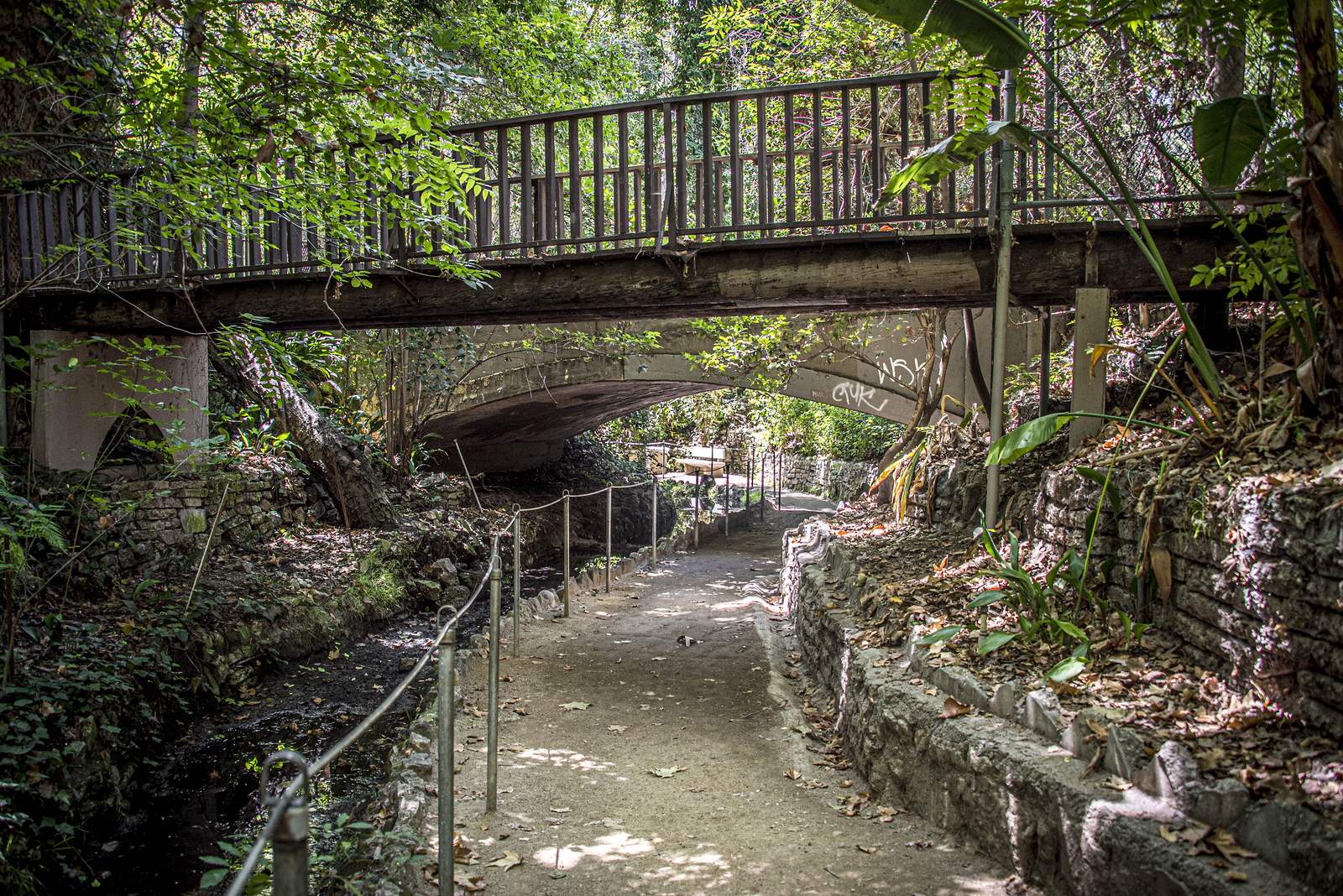 A wooden footbridge crossing over the shaded Fern Dell trail in Griffith Park