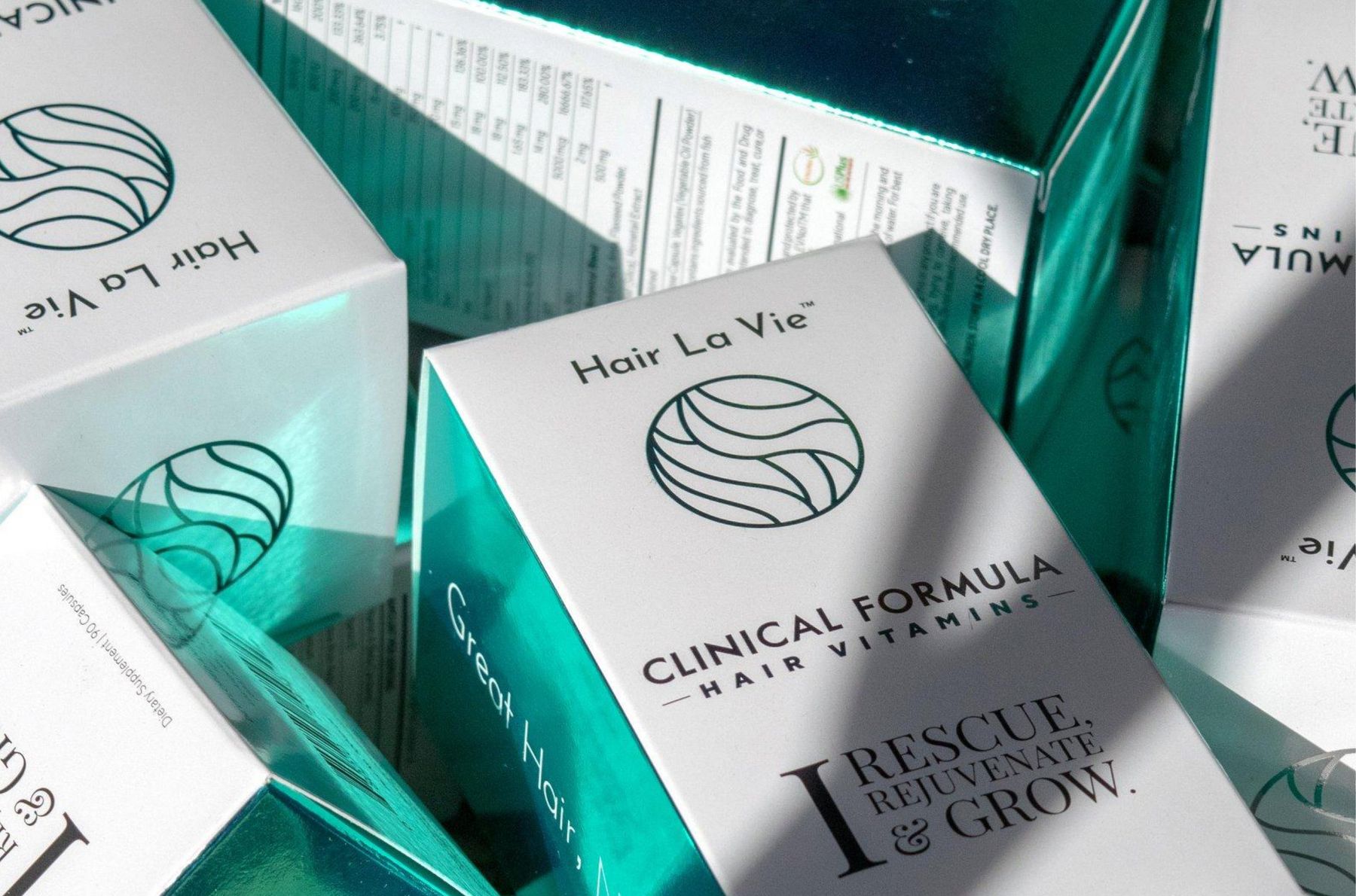 Hair La Vie Clinical Formula cartons in teal foil, close up