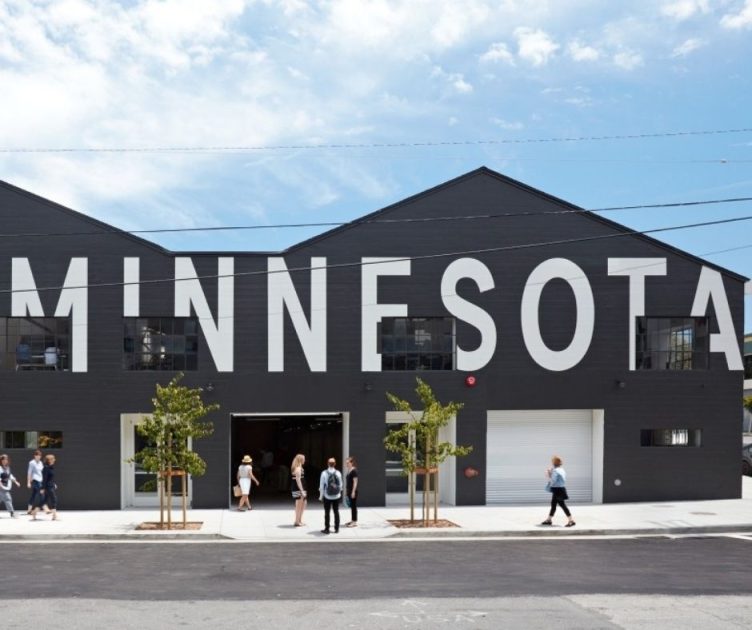 The black, gabled front of Minnesota Street Project in Dogpatch, with its name in big white letters