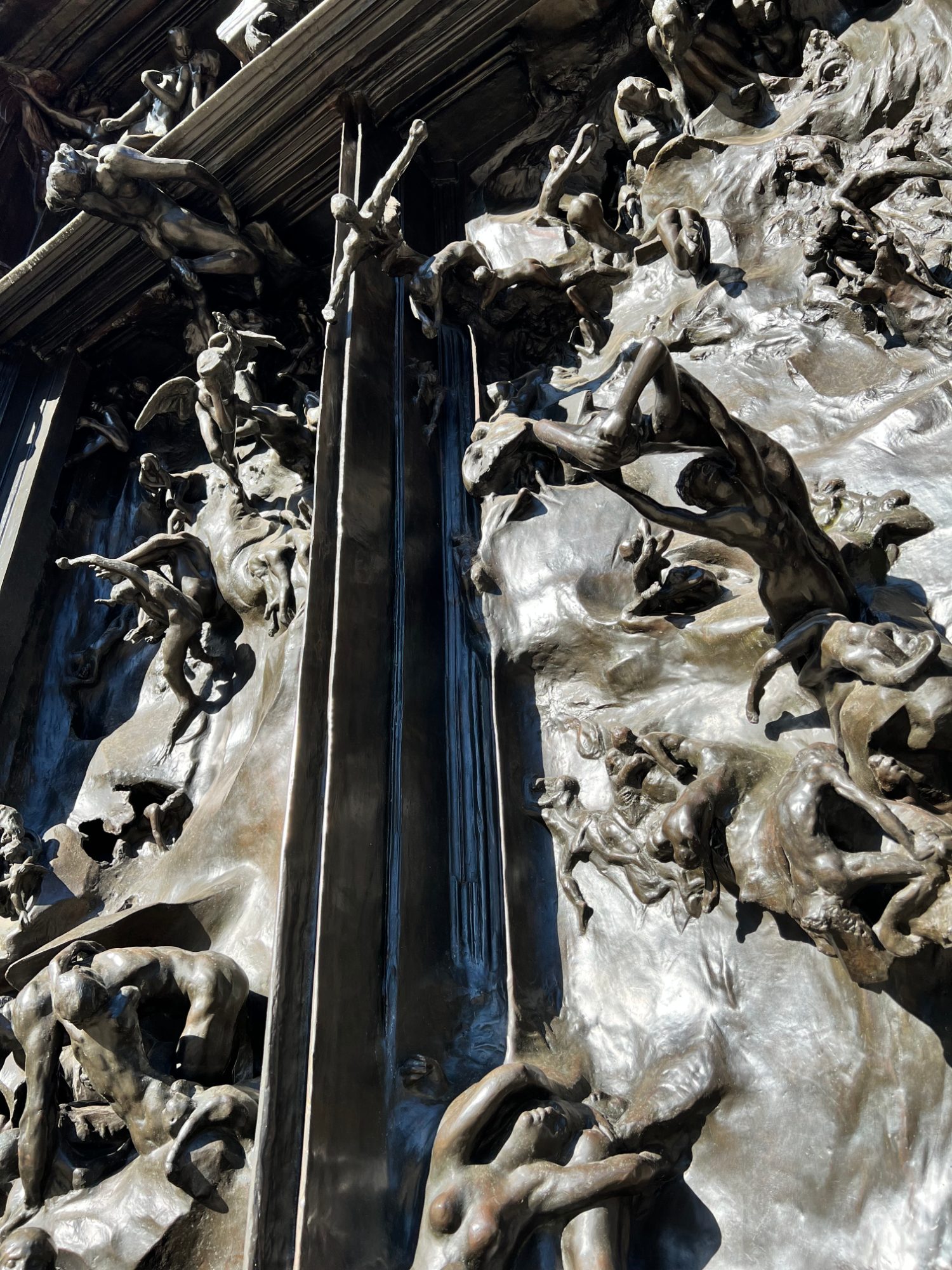 Detail of the crowded dark bronze figures on Rodin's The Gates of Hell in the Rodin Sculpture Garden at Stanford