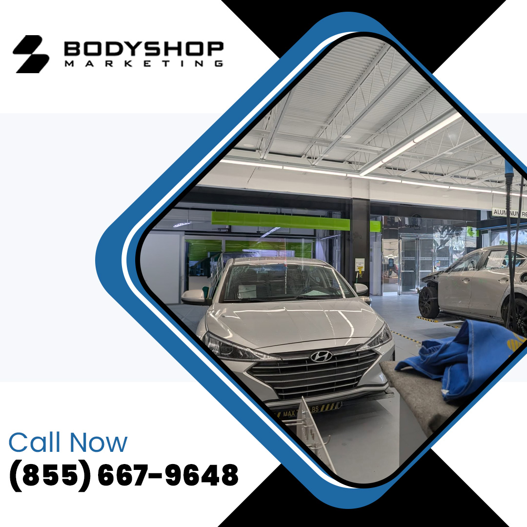 A silver sedan parked inside a modern collision repair shop with a Call Now phone number button.
