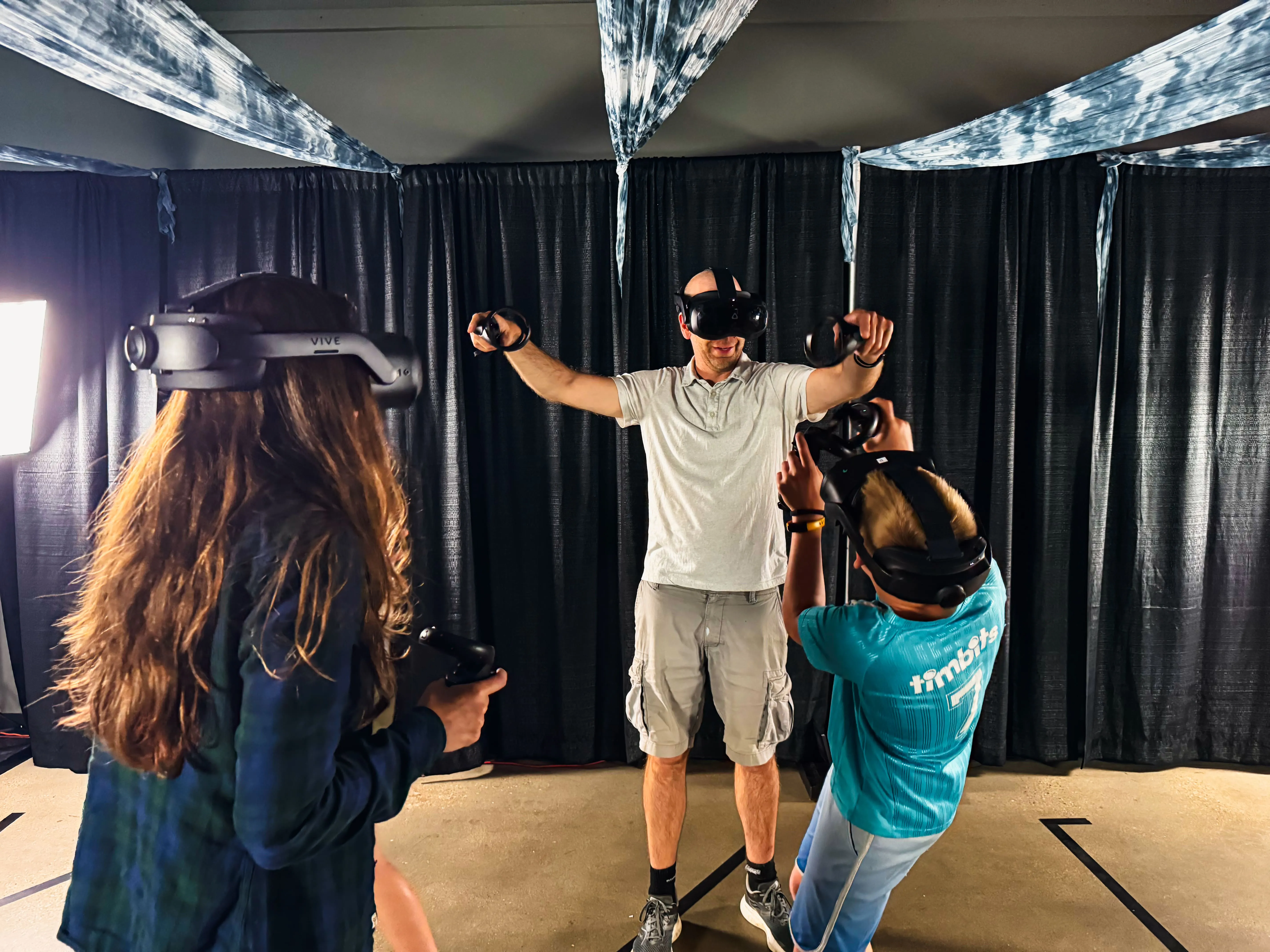 An Adventure Portal team member fitting a guest with a headset before a session