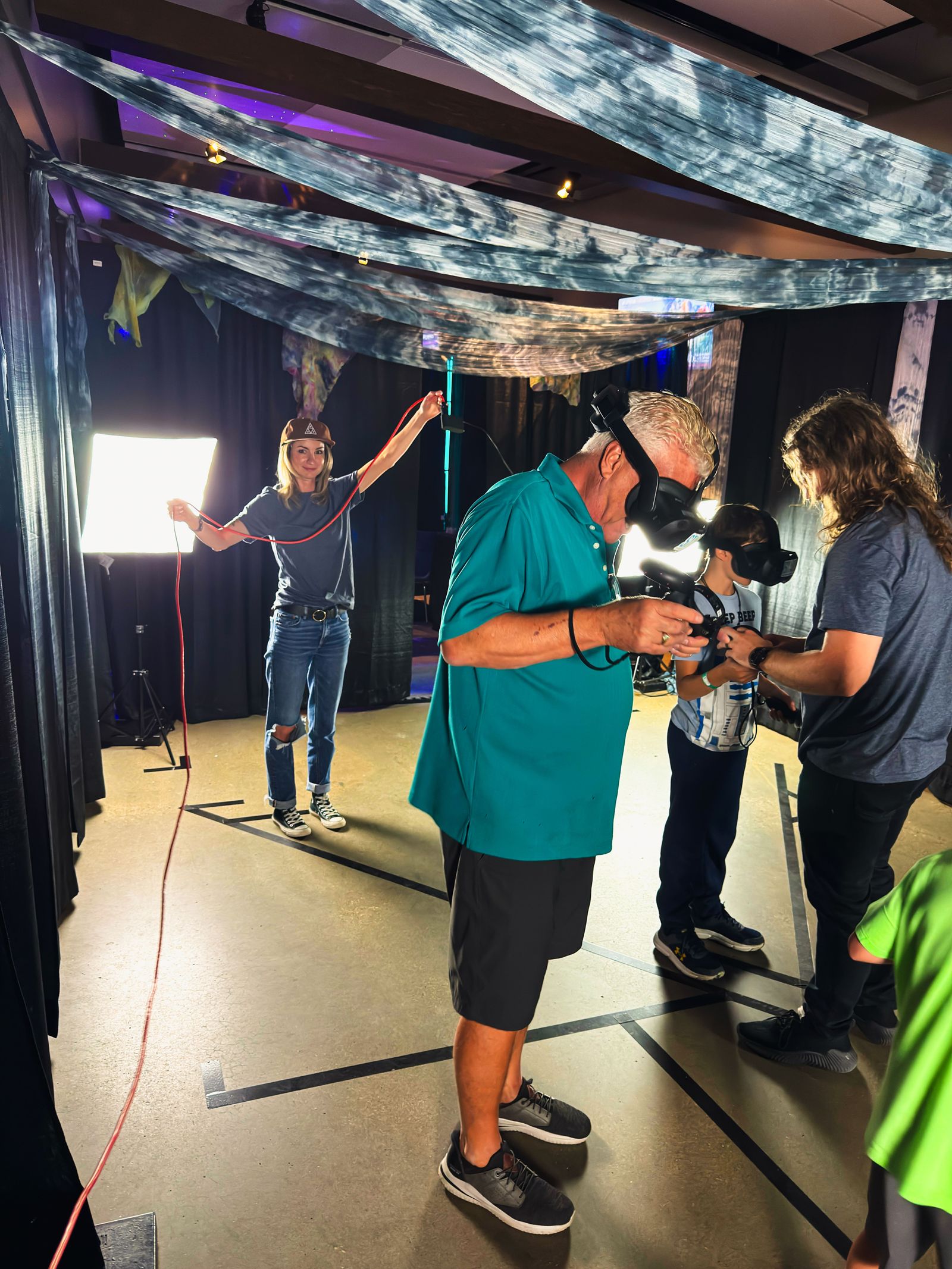 An Adventure Portal staff member fitting a guest with a VR headset before a Step Into Webb session
