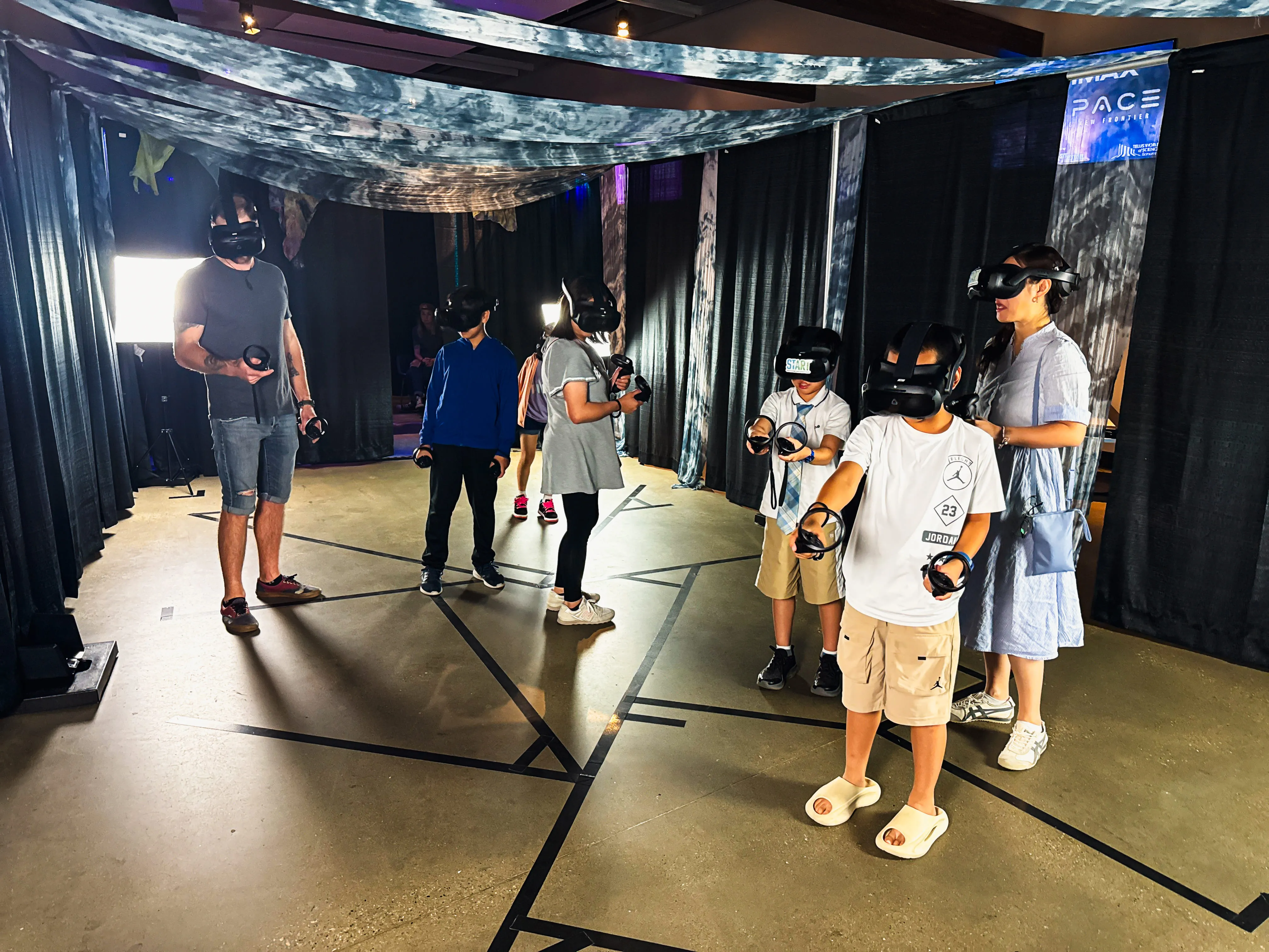 A full session underway, with guests spread across the arena in VR headsets beneath the draped ceiling.