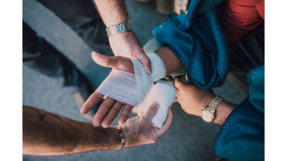 Pflegekraft legt Verband an einer Hand an