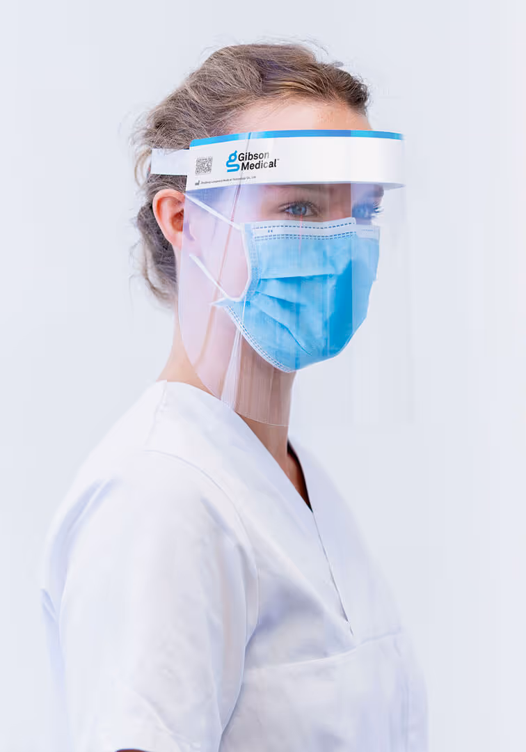 A woman wearing a face protective mask from the brand Gibson Medical