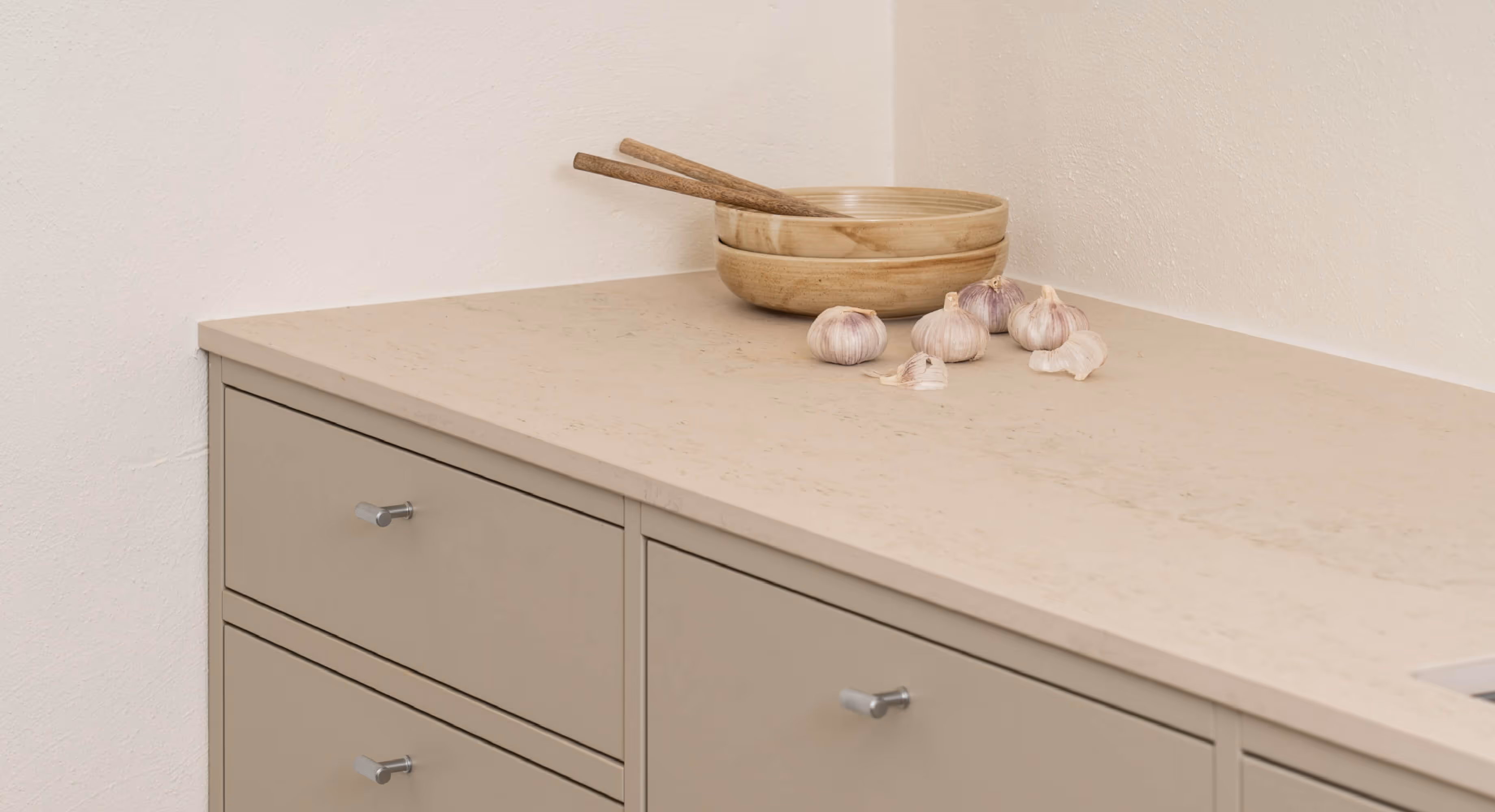 a counter top with a bowl with garlic on the side