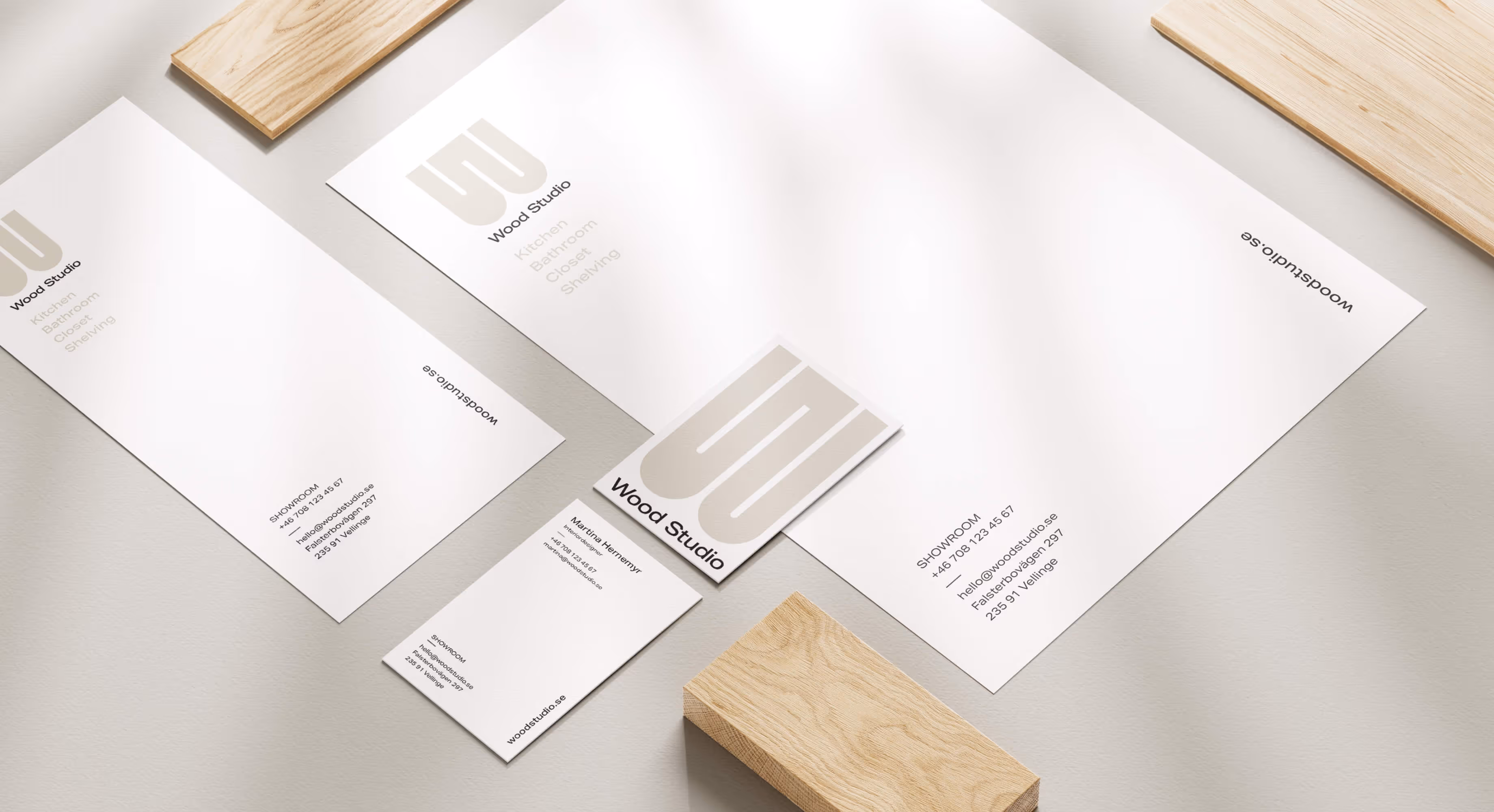 Business cards and flyers showing of the design for Wood Studios brand