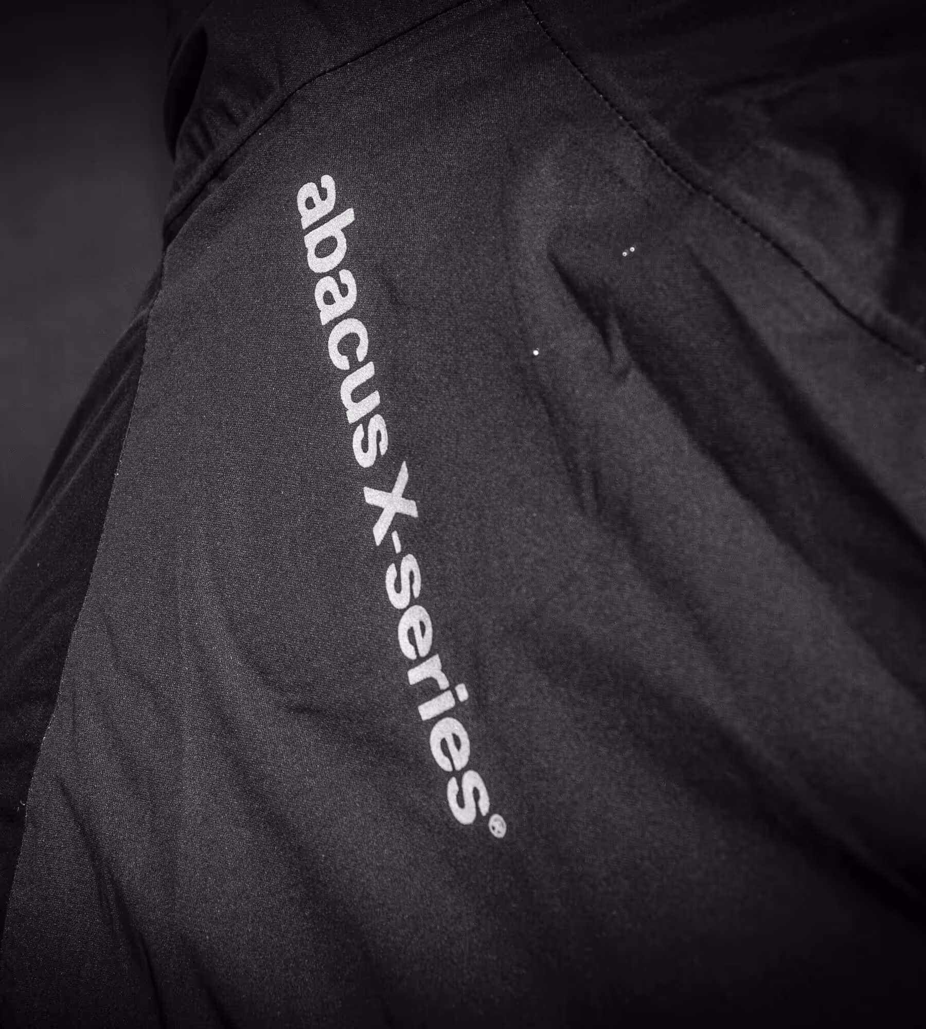 Close up photo on the logo abacus x-series on a piece of clothing.