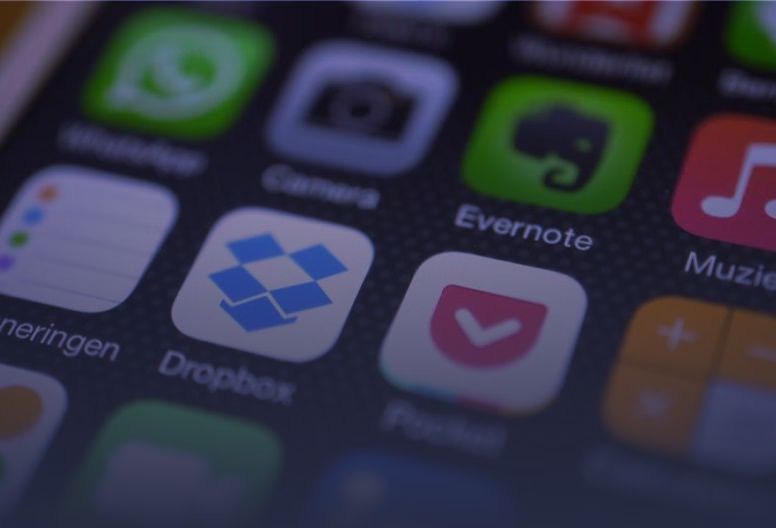 Close-up of a smartphone screen showing app icons including Dropbox, Evernote, and Pocket.