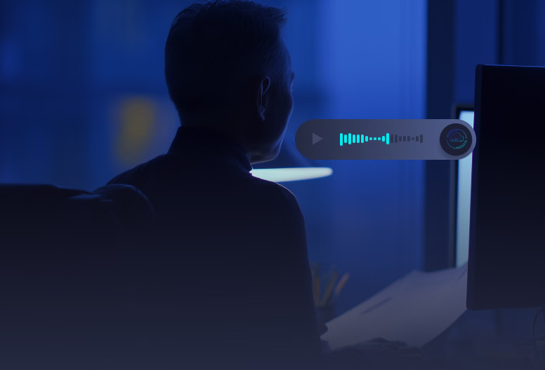 Person in a dark room facing a computer screen with digital sound wave visualization.