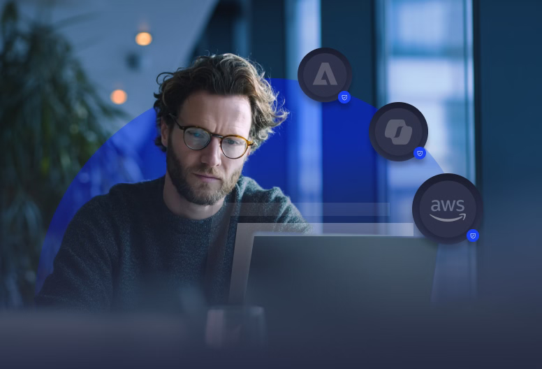 Man with glasses working on a laptop indoors with icons representing cloud services above the screen.