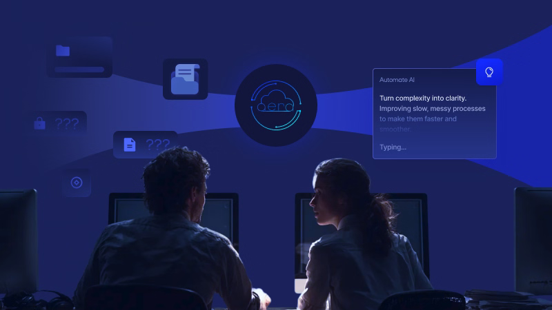 Two people sitting side-by-side in front of computers in a dark room with holographic interface displaying AI automation text and icons above them.