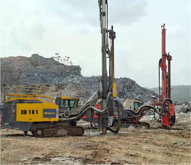 Epiroc and Sandvik drill rigs at an open pit mine