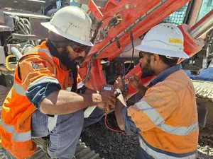 DCA systems team checking drill rigs at on open pit mine