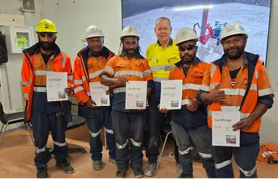Esa Yrjänä with drill operator training participants in Papua New Guinea